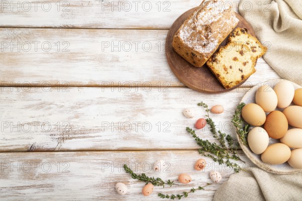 Homemade easter pie with raisins and eggs on plate on a gray concrete background and linen textile.