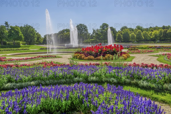 Garden parterre at the New Palace with flowerbeds and fountain in the Schleissheim Palace complex,