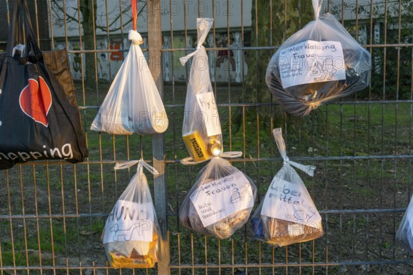 Gift fence with donations for the homeless and needy, food, hygiene articles, clothing, in Essen