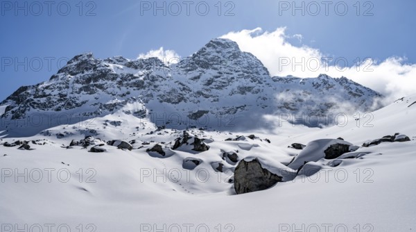 Picturesque snow-covered mountain landscape with Piz Kesch summit, Bündner Haute Route ski tour,