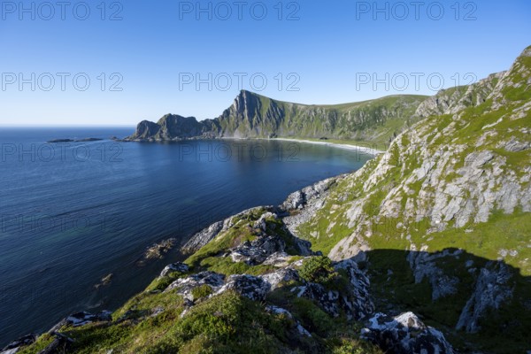 View of coastal landscape, cliffs with peak Måtind, Høyvika beach and sea, hike to the peak of