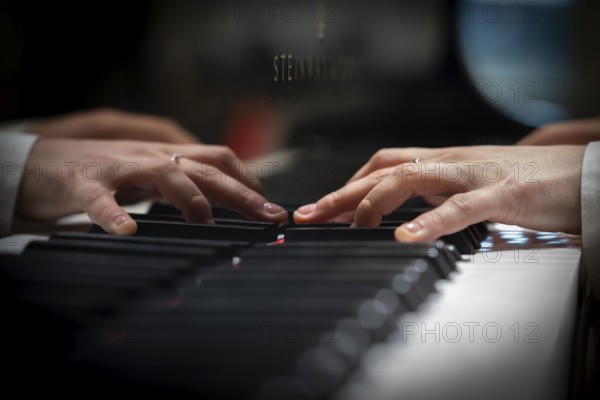 Hands of a young pianist playing on the keyboard of a Steinway & Sons grand piano, Stuttgart,