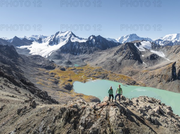 Hiker at the pass at 4000m, aerial view, mountains with glacier, mountain pass and mountain lake