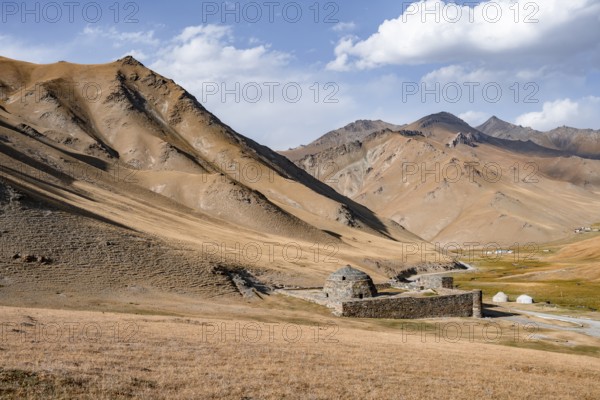Historic caravanserai Tash Rabat from the 15th century, with yellow hills, Atbashy district in the