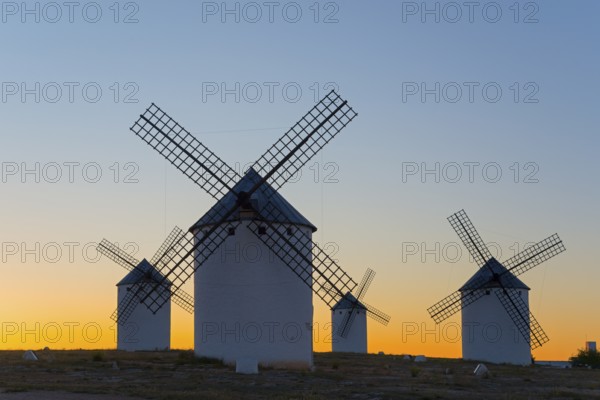 Windmills silhouetted against a soft evening sky, Campo de Criptana, Ciudad Real province,