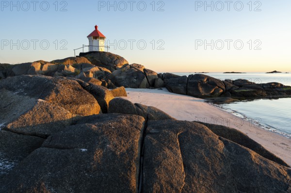 Seascape on the Lofoten Islands. The small lighthouse on the sandy beach of Eggum. Sea and rocks.
