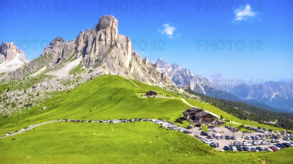 Panoramic view capturing the mountain shelter and parking area at passo giau in the italian