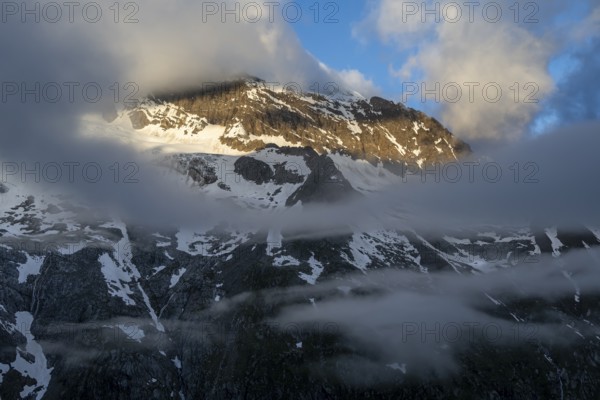 Cloudy mountain landscape in dramatic morning light, Griesferner peak with snow, Berliner Höhenweg,