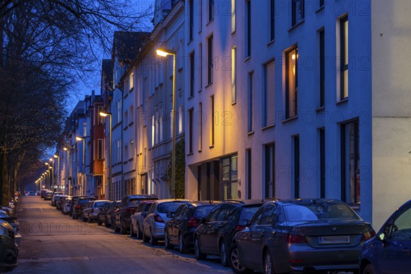 Residential street, many apartment buildings in a residential neighbourhood, evening, lantern