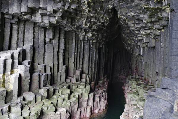 Dark cave with impressive basalt columns and deep water in a natural setting, Staffa, Inner