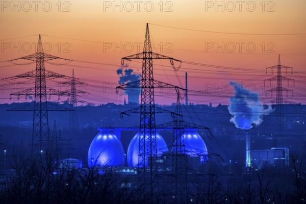 Digesters of the Emscher sewage treatment plant Bottrop, illuminated, high-voltage pylons, North