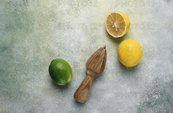 Wooden citrus reamer, manual lemon juicer, made of acacia wood, with citrus fruits on the table,