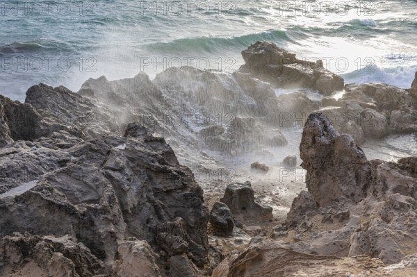 Sea water lashes over the eroded rocks on Salines beach, Ibiza, Balearic Islands, Mediterranean