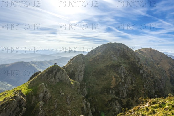 Hikers enjoy the stunning panoramic view from the summit of aiako harria, also known as penas de
