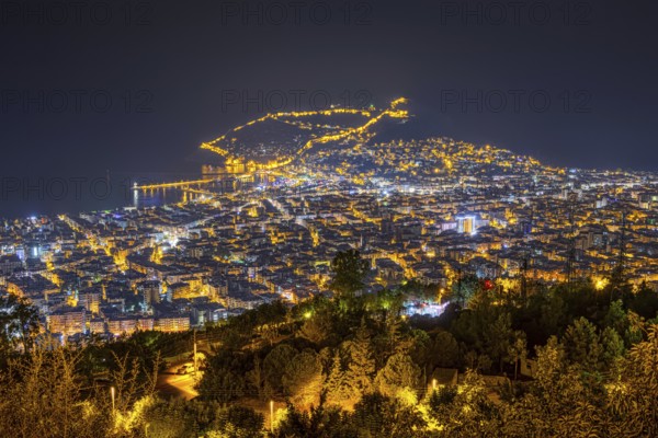 The lights of the city of Alanya on the Turkish Riviera glow in the evening, Alanya, Antalya,