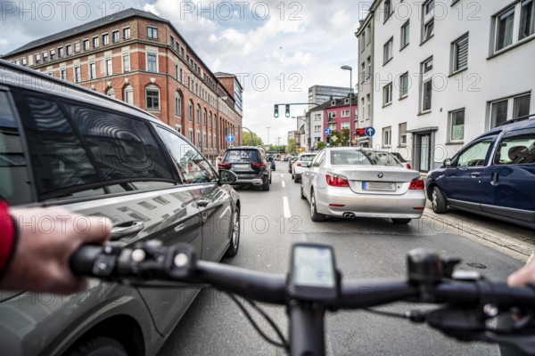 Cycling in the city, city centre road, no cycle lane, two-lane traffic in both directions,
