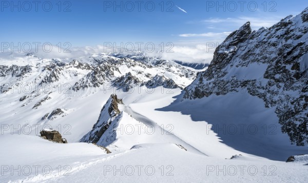 Mountain ridge of Piz Kesch, ascent on Piz Kesch or Piz d'Es-cha in winter, spectacular mountain