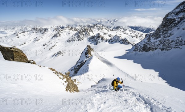 Mountaineer with ice axe and crampons, ascent through steep snowfield to Piz Kesch or Piz d'Es-cha