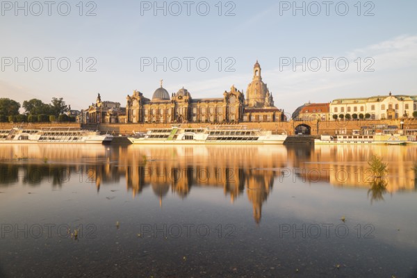 Silhouette of the Old Town with reflection in the Elbe in the morning, steamboats on the