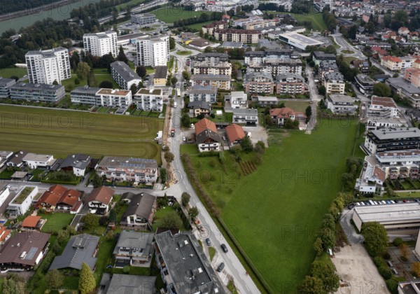Drone image, grassland between built-up residential area, residential buildings and high-rise