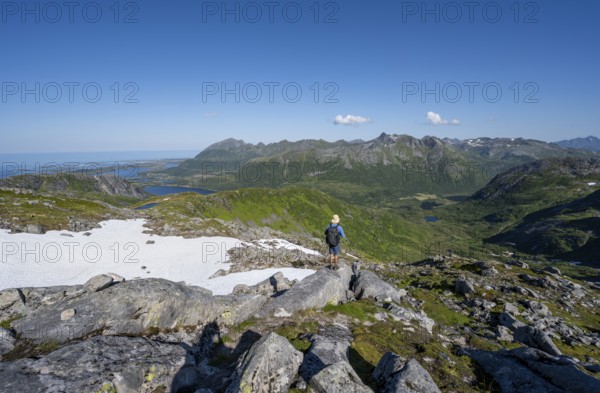 View of mountains and fjord landscape, mountain panorama, mountaineer at the summit of Rundfjellet,