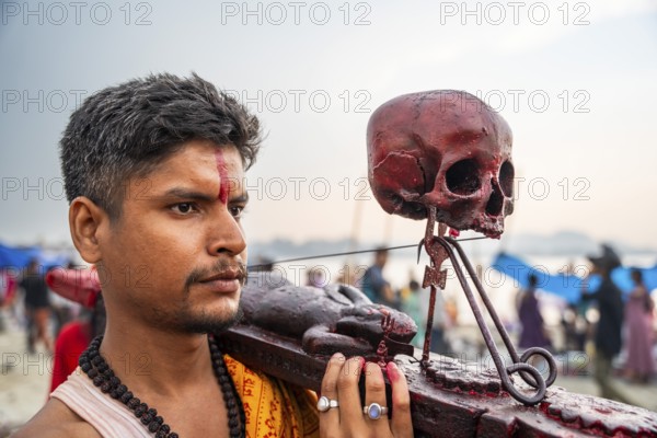A Hindu priest arrives awith a human skull on the bank of Brahmaputra river on Ashoka Ashtami