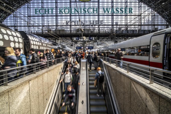 Cologne Central Station, escalators to and from the platform, passengers waiting for the train,