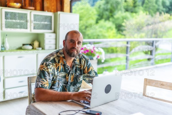 Digital nomad working on laptop in a mountain chalet, enjoying the freedom of remote work and a
