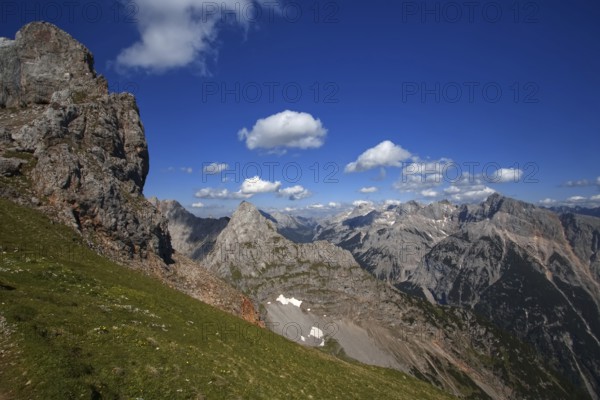 Fascinating view of high mountain peaks and clouds under a blue sky, Karwendel, Mittenwald,