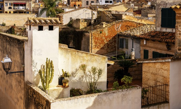 View of Mediterranean houses, roofs and courtyards from the town wall, Alcudia, Majorca, Spain,