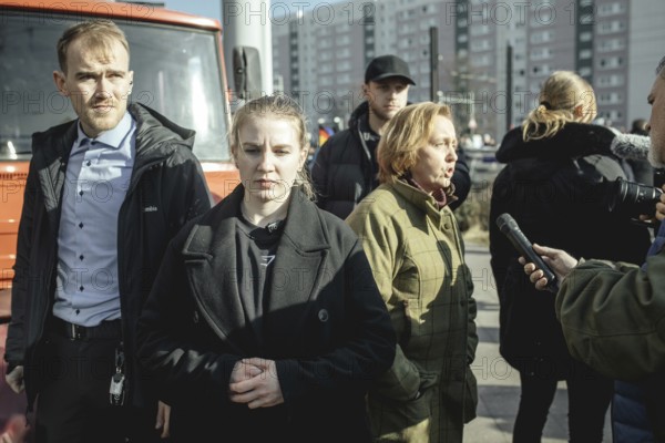Bodyguards and Beatrix von Storch (in the background) at the final rally of Beatrix von Storch and
