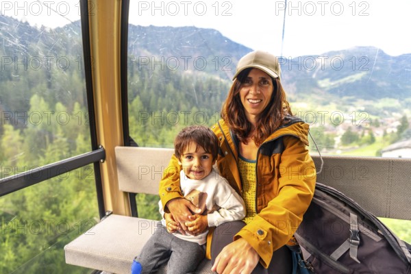 Tourists enjoying a scenic cable car ride in the italian dolomites, taking in the breathtaking