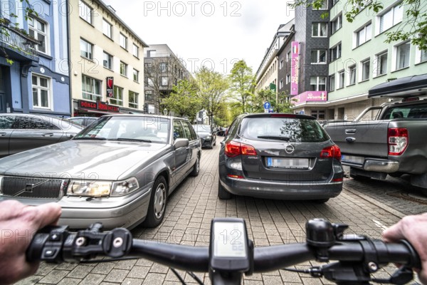 Cycling in the city, inner-city street, cycle lane, bicycles have priority, two-lane traffic with