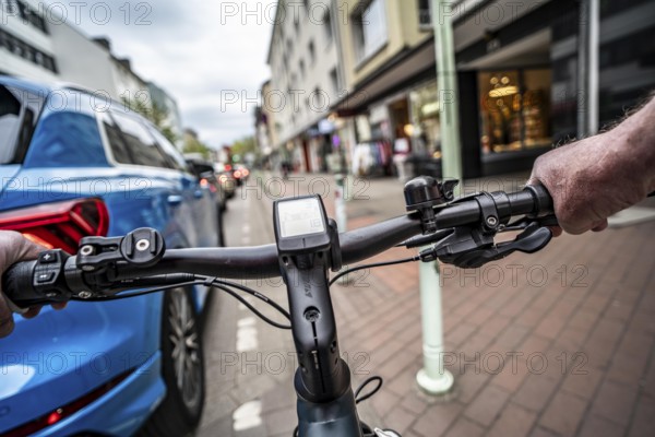 Cycling in the city, inner-city street, cycle lane, bicycles have priority, two-lane traffic with