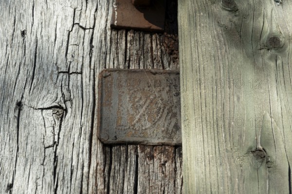 An old rusty hidden tin sign on a half-timbered barn, Wildeshauser Geest, Bassum, Diepholz, Lower