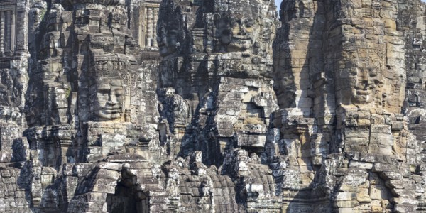 Panoramic image of giant stone-carved faces of the Bodhisattva Lokeshvara, also known as