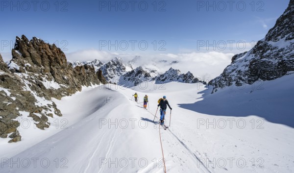 Ski tourer with rope, rope team on the Vadret da Porchabella glacier on the ascent to the summit of