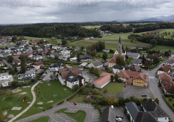 Drone shot, view of village with parish church, Rutzenmoos, Hausruckviertel, Upper Austria,