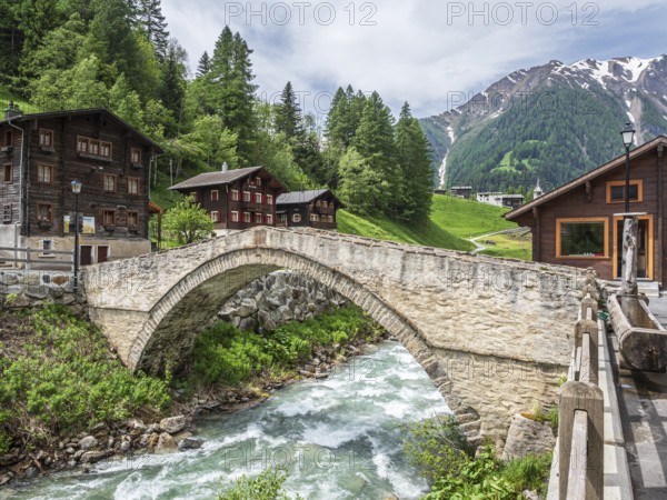 Village Binn, bridge over river Binna, traditional wooden houses, church, Valais, Switzerland,