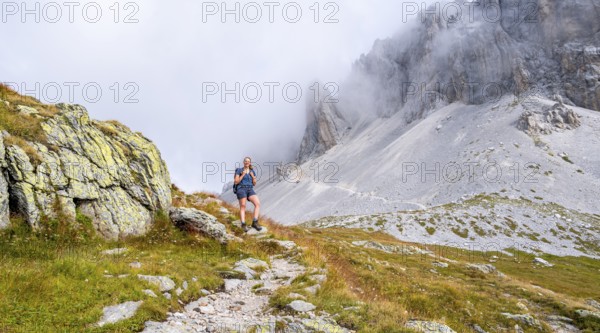 Hiker on the ascent to the Great Kinigat, Carnic Main Ridge, Carnic High Trail, Carnic Alps,