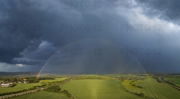 Thunderstorm cell with rainbow over fields near Krebs in the Osterzgebirge, Krebs, Saxony, Germany,
