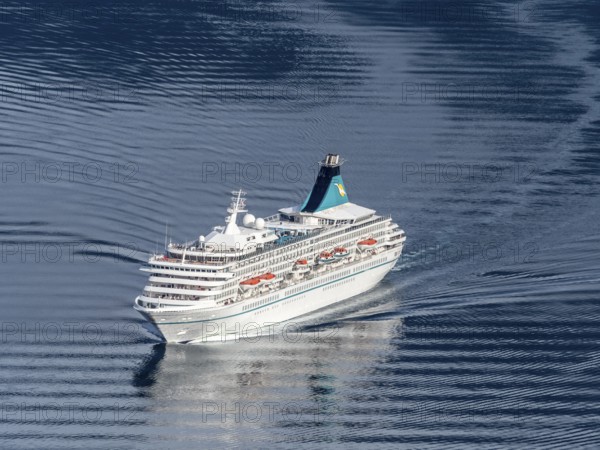Cruise ship Artania leaving the Geirangerfjord into fjord Synnylvsfjord, seen from viewpoint at