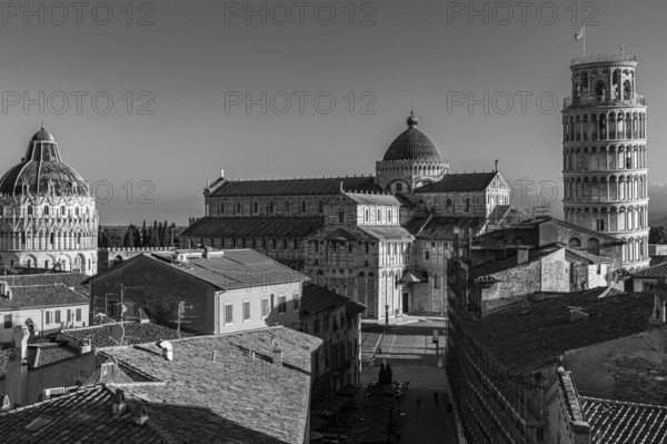 Above the roofs of Pisa, behind the Baptistery, the Cathedral of Santa Maria Assunta and the