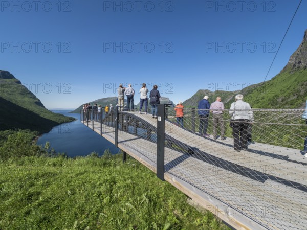 Tourist group visits viewing platform at Bergsbotn, viewpoint over fjord Bergsfjorden, Senja