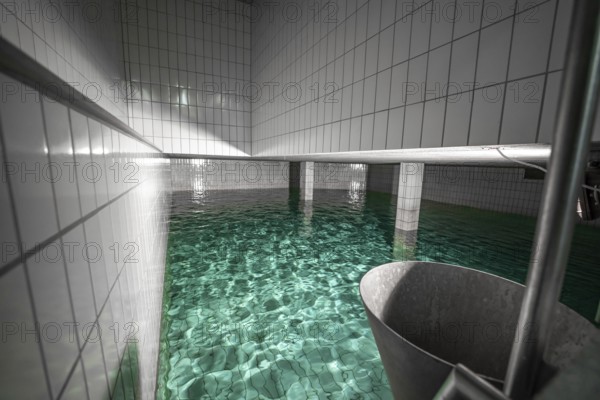 Large water basin with tiled walls and reflecting water, ENCW Netze Calw waterworks, Calw, Black