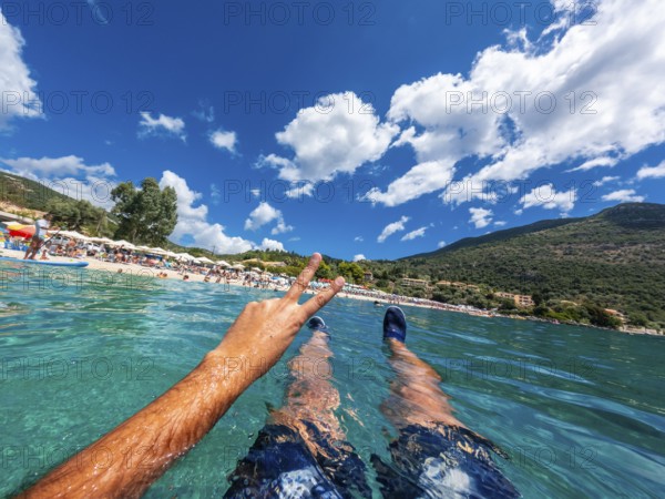 Resting in the sea on the beach in summer of Paralia Mikros Gialos in the south of the island of