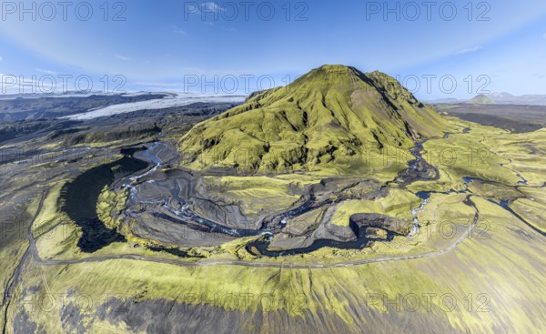 River along road F232 Öldufellsleid, slopes of Mt. Öldufell, moss-covered hill in black lava sand,