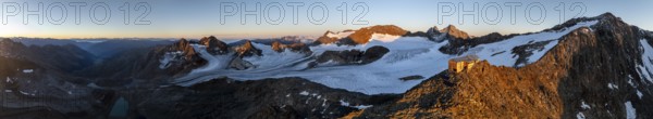 PanoraAtmospheric sunrise in picturesque mountain landscape, alpenglow, aerial view, mountain hut