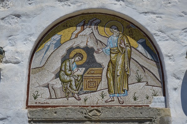 A mosaic wall painting on a church shows two holy figures in a religious scene, St John the