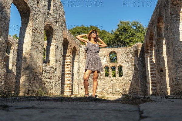 A tourist visiting in Great basilica in the archaeological ruins of Butrint or Butrinto National
